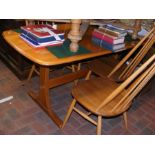 An Ercol 'Light Dawn' dining table with four stick