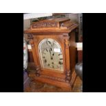 An oak cased chiming mantel clock - 44cms high