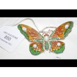 A solid silver butterfly set with opal and emerald