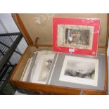 A suitcase containing vintage engravings and prints