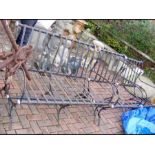 A three piece cast metal garden settee and chairs
