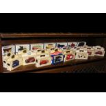 A collection of various boxed die cast vans