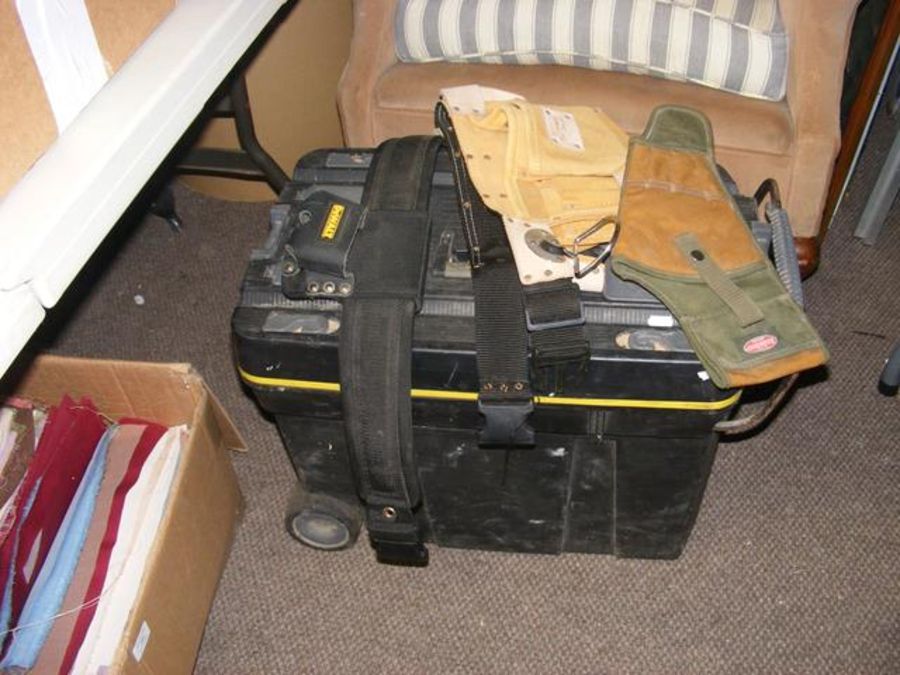 A black plastic toolbox, together with tool belts,