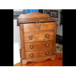 A miniature oak apprentice chest of drawers