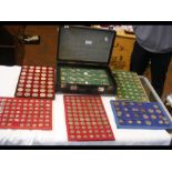 A suitcase containing collectable coins in trays,