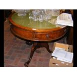 A reproduction drum table with green leather top -