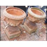 A pair of old terracotta plant pots on stand
