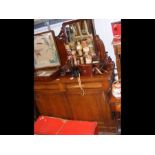 A Victorian mahogany chiffonier with carved back,