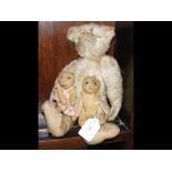 An old straw filled teddy bear together with two s