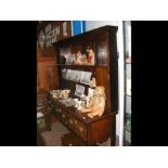 A Georgian oak dresser with plate rack over and th