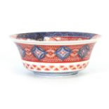 AN IMARI DEEP FOOTED BOWL WITH EVERTED RIM with detailed polychrome decoration in blues, green and