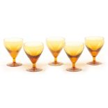 A SET OF FIVE 19TH CENTURY AMBER COLOURED RUMMERS / WINE GLASSES 11cm high.