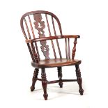 AN EARLY/MID 19TH CENTURY CHILD'S YEW WOOD WINDSOR CHAIR with shaped tapering fret-cut centre splat,