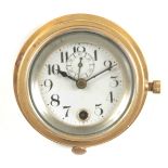 A BRASS CASED CAR CLOCK with porcelain dial and subsidiary seconds 11cm diameter