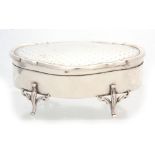 A GEORGE V LARGE SHAPED OVAL SILVER JEWELLERY CASKET with decorated top and lined interior raised on