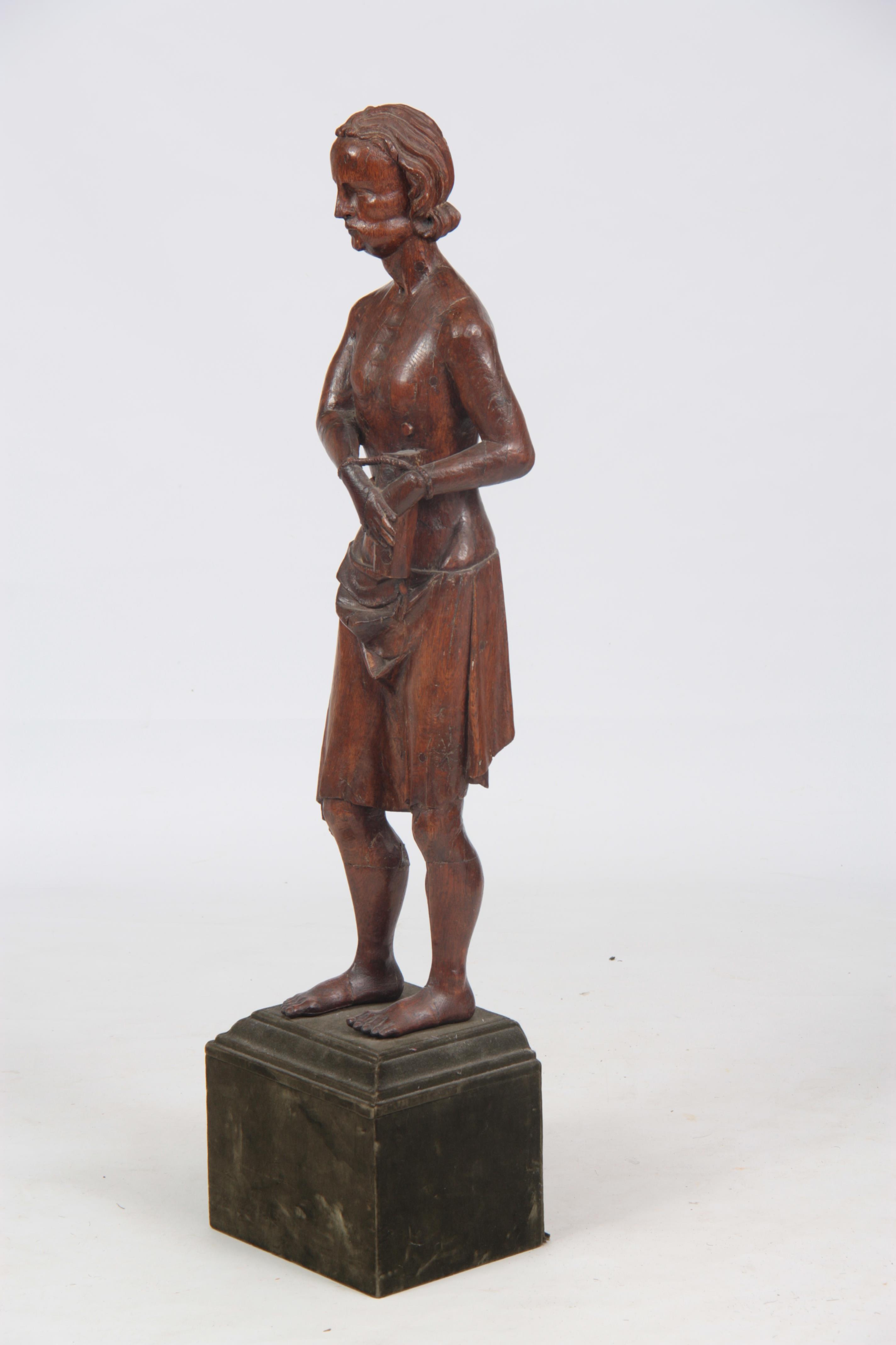 A 14TH / 15TH CENTURY CARVED OAK STATUE OF ST. SEBASTIAN mounted on a velvet-covered square base - Image 3 of 4