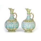 A PAIR OF CONTINENTAL LARGE BULBOUS PORCELAIN EWERS each with all over raised leafwork and