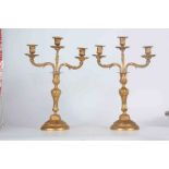 A PAIR OF 19TH CENTURY ORMOLU THREE BRANCH CANDELABRA with twisted rococo style stems on circular