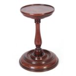 AN 18TH CENTURY MAHOGANY TURNED CANDLE STAND with ring turned bulbous stem and moulded base 22cm