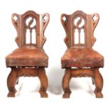 A SET OF FOUR ARTS AND CRAFTS GOTHIC STYLE OAK SIDE CHAIRS IN THE MANNER OF PUGIN with shaped