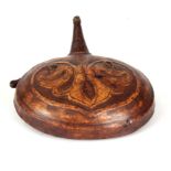 A 19TH CENTURY INDIAN TOOLED LEATHER POWDER FLASK with ironwork funnel and leaf designed circular