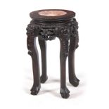 A SMALL 19TH CENTURY PROFUSELY CARVED CHINESE HARDWOOD CIRCULAR JARDINIERE STAND with marble inset