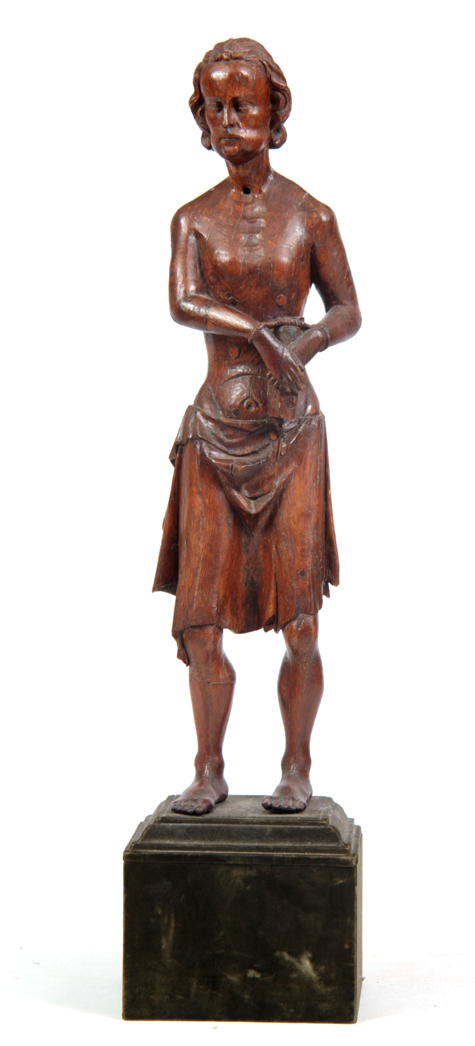 A 14TH / 15TH CENTURY CARVED OAK STATUE OF ST. SEBASTIAN mounted on a velvet-covered square base