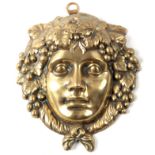 A 19TH CENTURY BRASS HANGING WALL MASK 17cm high 15cm wide