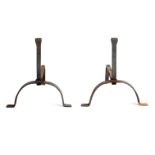 A PAIR OF WROUGHT IRON FIRE DOGS with arched footed fronts 40cm high 50cm deep