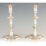 A PAIR OF GEORGE III SOLID CAST SILVER FOUR SHELL CANDLESTICKS