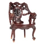 A GOOD 19TH CENTURY CHINESE CARVED HARDWOOD ARMCHAIR with interlaced dragons surrounding a central