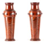 A PAIR OF EARLY 20TH CENTURY TURNED ROSEWOOD CYLINDRICAL VASES of tapering form with applied