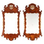 A PAIR OF GEORGE II WALNUT AND GILTWOOD HANGING MIRRORS with leaf work crests and floral decorated