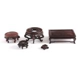 A COLLECTION OF FIVE CHINESE HARDWOOD STANDS the rectangular stand measures 26cm wide, 8.5cm high (