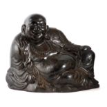 A 19TH CENTURY CHINESE CARVED HARDWOOD SCULPTURE OF A SEATED BUDDHA 48cm wide.