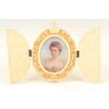 A LATE 19TH CENTURY MINIATURE ON IVORY OF A YOUNG LADY signed K.W.C. 1892 in a finely carved ivory