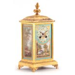 A 19TH CENTURY FRENCH GILT BRASS AND PORCELAIN PANELLED MANTEL CLOCK OF SMALL SIZE. The oblong