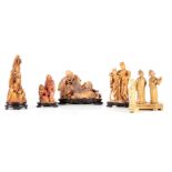 A GROUP OF SIX CARVED SOAPSTONE FIGURES of various tones and poses, four with hardwood bases.