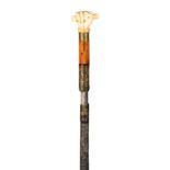 AN UNUSUAL 18TH CENTURY STEEL CASED SWORD STICK with Malacca and ivory pommel formed a fist;