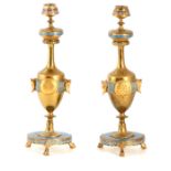 FERDINAND BARBEDIENNE. A PAIR OF LATE 19TH CENTURY FRENCH CHAMPLEVE ENAMEL AND ORMOLU CANDLESTICKS