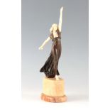 AN ART NOUVEU PATINATED BRONZE AND IVORY FIGURE modelled as a classical dancer with arms