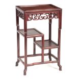 A 19TH CENTURY CHINESE HARDWOOD SIDE TABLE with dished top and carved scrolled openwork frieze,