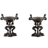 A PAIR OF LATE 19TH CENTURY BRONZE TAZZAS with stylised griffin supports and claw feet 27cm high