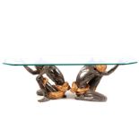 AN UNUSAL 20TH CENTURY ITALIAN COFFEE TABLE with thick cut glass top supported by two polychrome