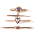 A COLLECTION OF FOUR 9CT GOLD AND AMETHYST BAR BROOCHES one set with small pearls, total app. weight