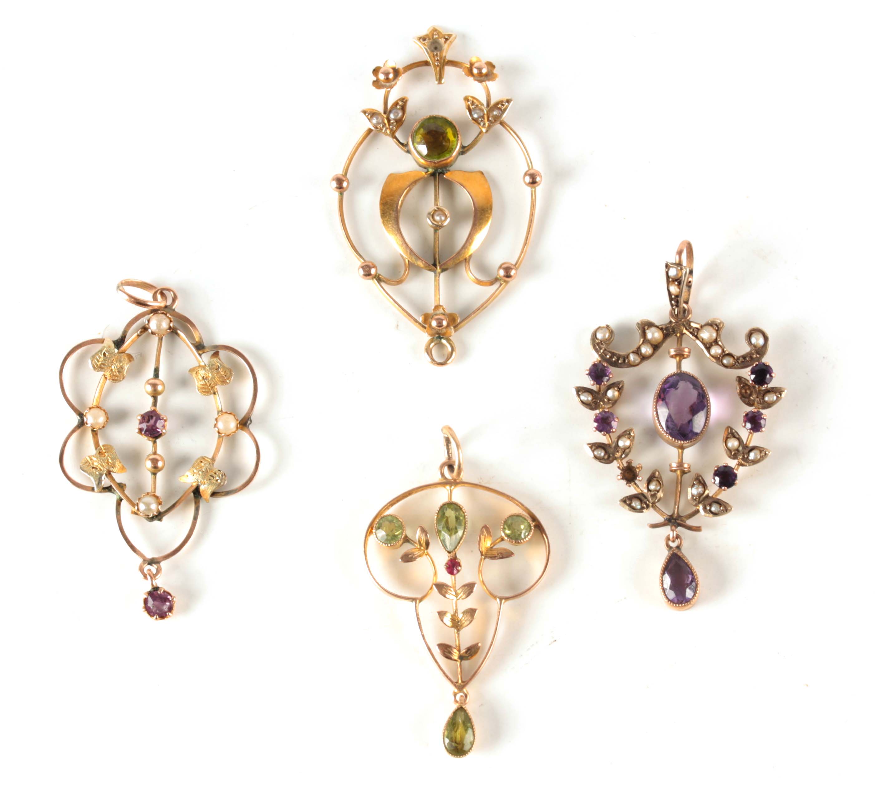 A COLLECTION OF FOUR ART NOUVEAU GOLD PENDANTS set with amethyst, ruby and pearls - total weight
