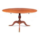 A LATE GEORGIAN SOLID SATINWOOD OVAL TILT TOP TABLE with moulded edge; raised on a ring turned