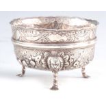 A VICTORIAN IRISH SILVER FOOTED BOWL with scalloped edge and embossed floral decoration raised on