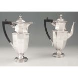 A PAIR OF GEORGE V SILVER COFFEE AND TEAPOTS of octagonal form with domed hinged lids and ebonized