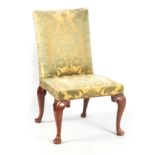 A QUEEN ANNE WALNUT UPHOLSTERED SIDE CHAIR with green silk damask upholstery; standing on shaped